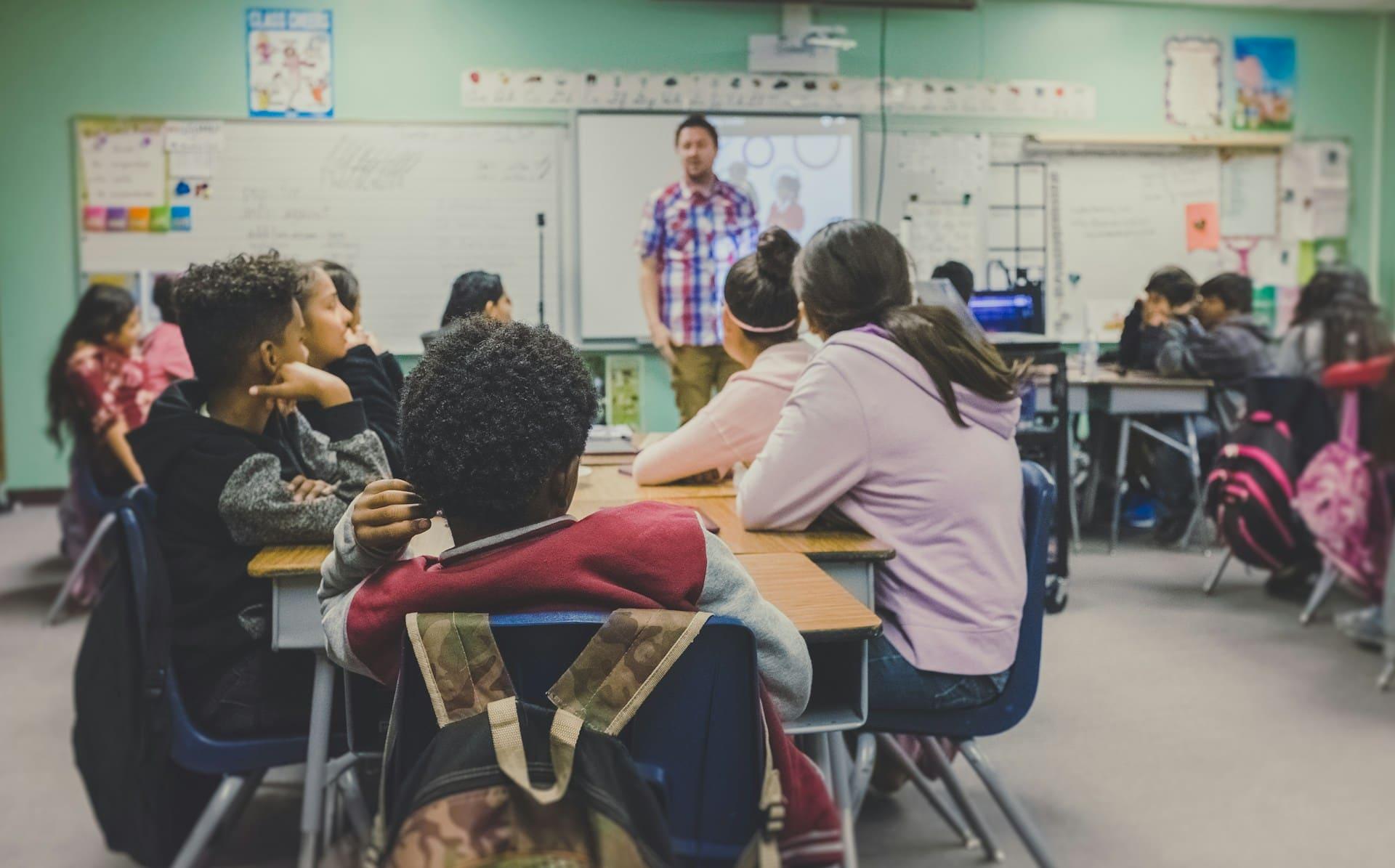 children in the classroom listening to teacher